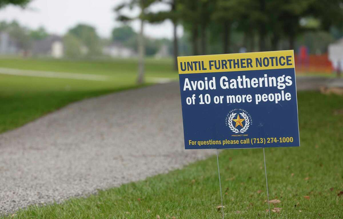 A sign warning people not to gather at Tom Bass Regional Park III Wednesday, April 8, 2020, in Houston.