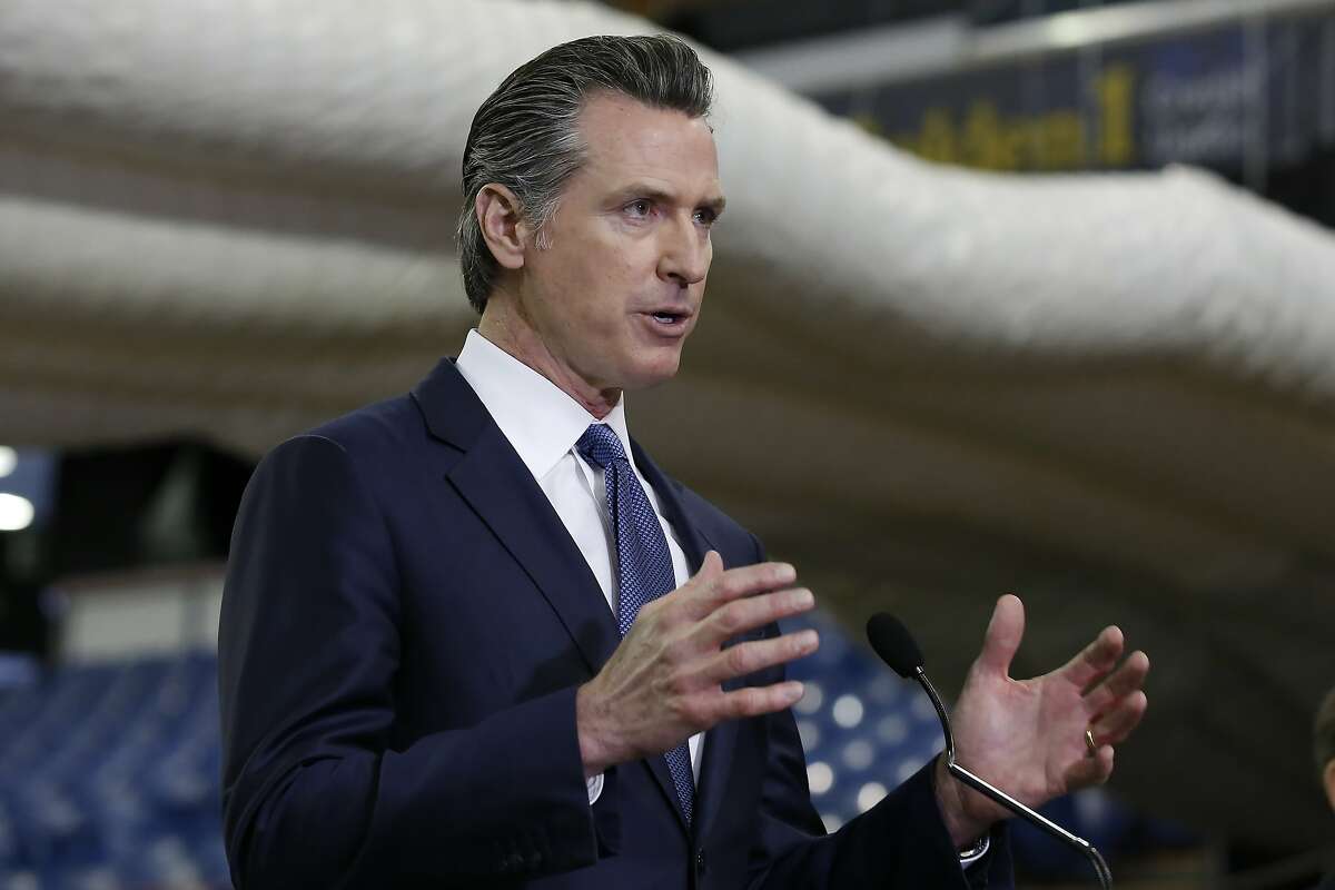 In this Monday April 6, 2020 file photo, Gov. Gavin Newsom discusses the acquisition of the Sleep Train Arena for use as a field hospital, after touring the facility, in Sacramento, Calif.