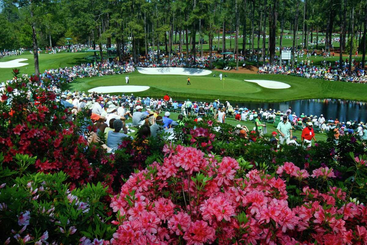FILE - In this April 4, 2011, file photo, golf fans watch on the par three 16th hole during a practice round for the Masters at Augusta National Golf Club in Augusta, Ga. For the first since a three-year suspension caused by World War II, this tradition unlike any other won't be held in its usual slot on the calendar, where it serves as sort of an unofficial kickoff to spring. (Tim Dominick/The State via AP, File)