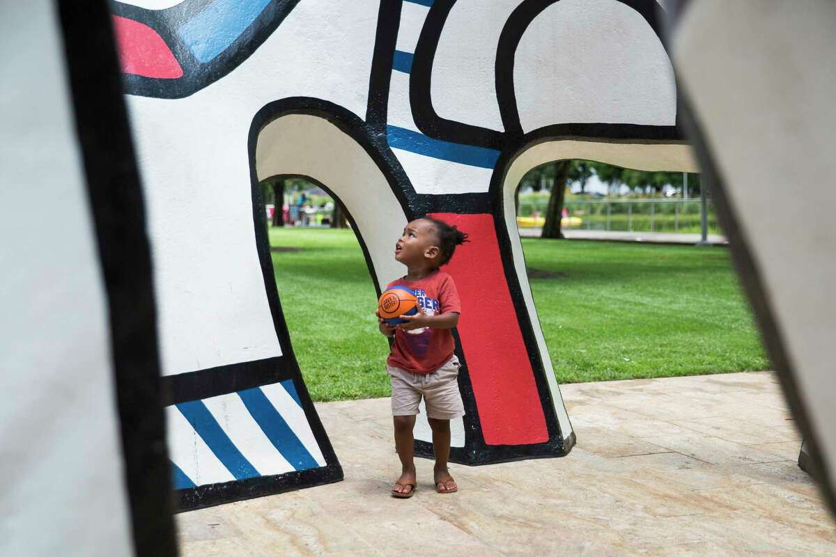 King Richardson, 2, wanders in the sculpture Monument Au Fantome by French sculptor Jean Dubuffet at Discovery Green park in Houston.