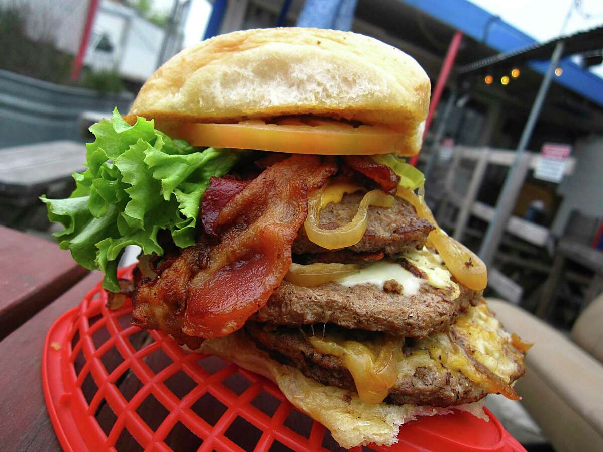 The Jack Burton Burger weighs in at a pound with triple meat, bacon, cheese and the trimmings at Papa's Burgers.