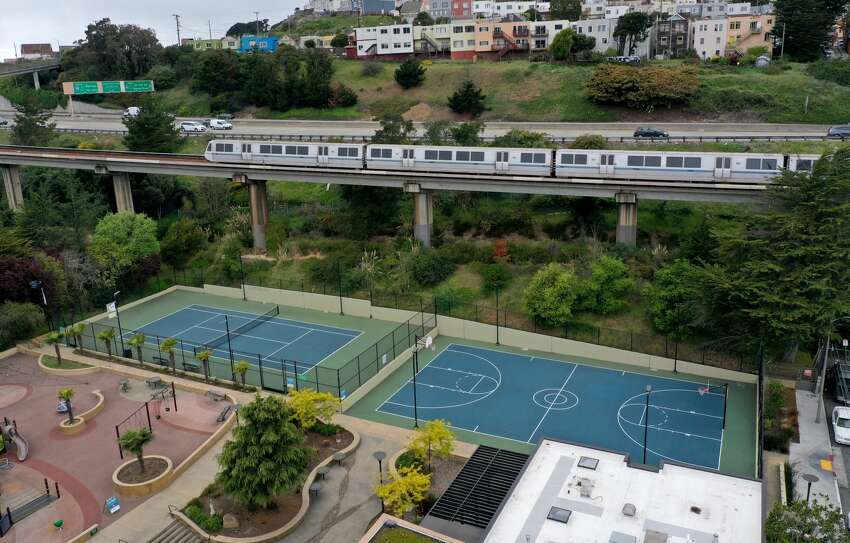 A Bay Area Rapid Transit (BART) train passes an empty playground on April 08, 2020 in San Francisco, California. BART announced that it is slashing daily service as ridership falls dramatically due to the coronavirus shelter in place order. Starting Wednesday, regular Monday through Friday service will be reduced to running trains every half hour between 5 am and 9 pm.