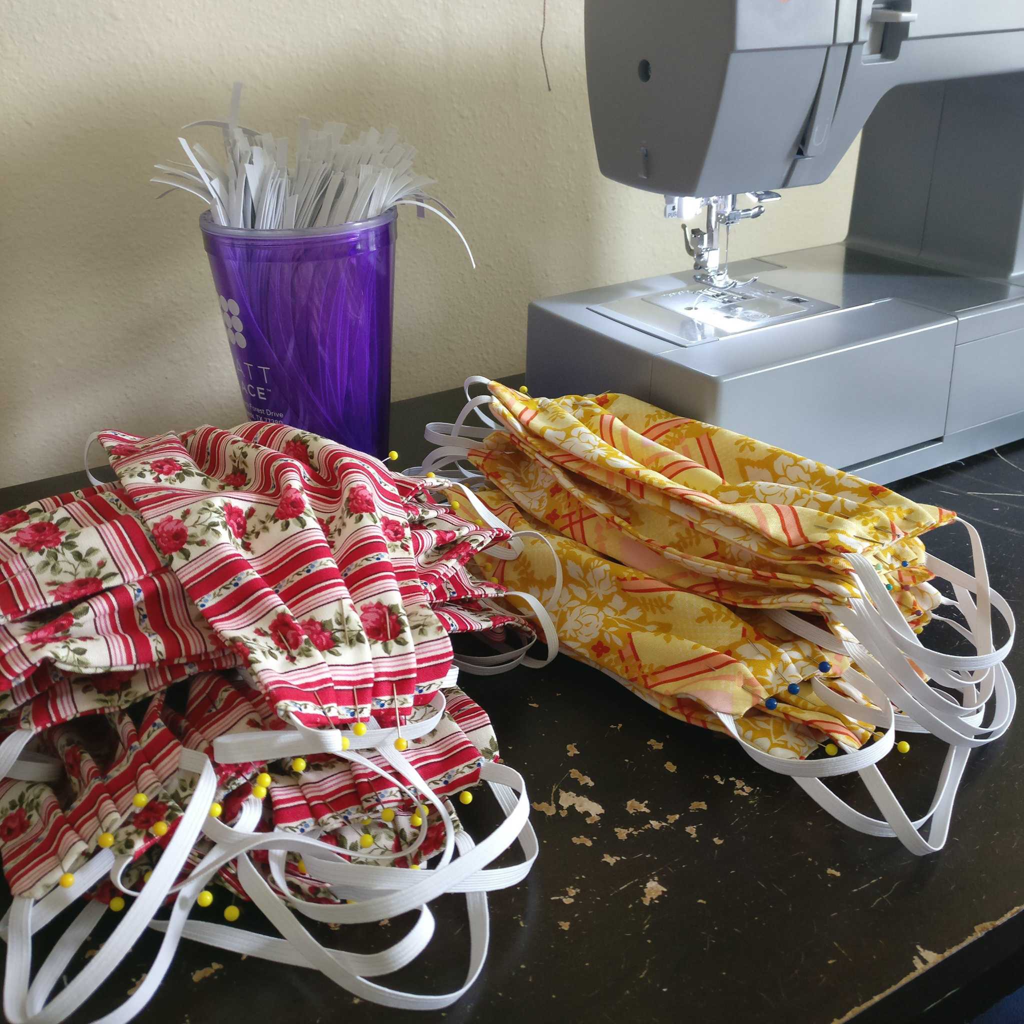 Local professional costume maker sewing hundreds of face masks for