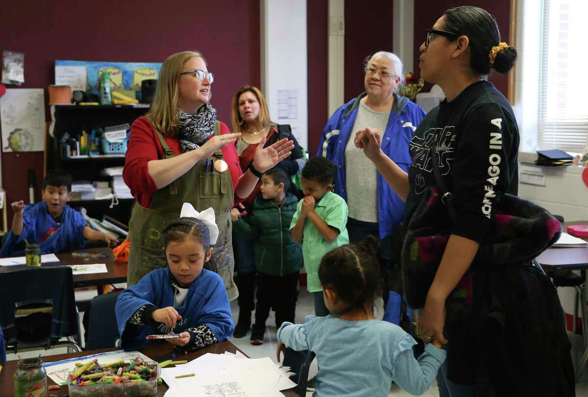 Hatchett Elementary School art teacher Ann Fletcher, center, talks with students and parents from Pre-K 4 SA during a tour of the school Feb. 26 at a "Welcome to Kinder" event.