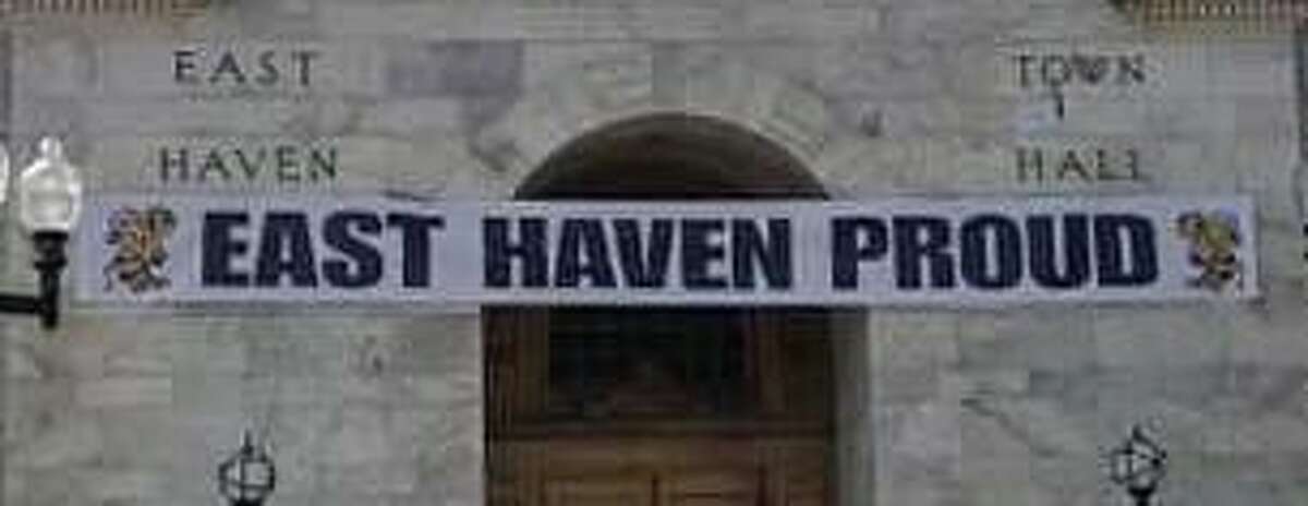 An “East Haven Proud” banner hangs across the entrance to East Haven Town Hall.