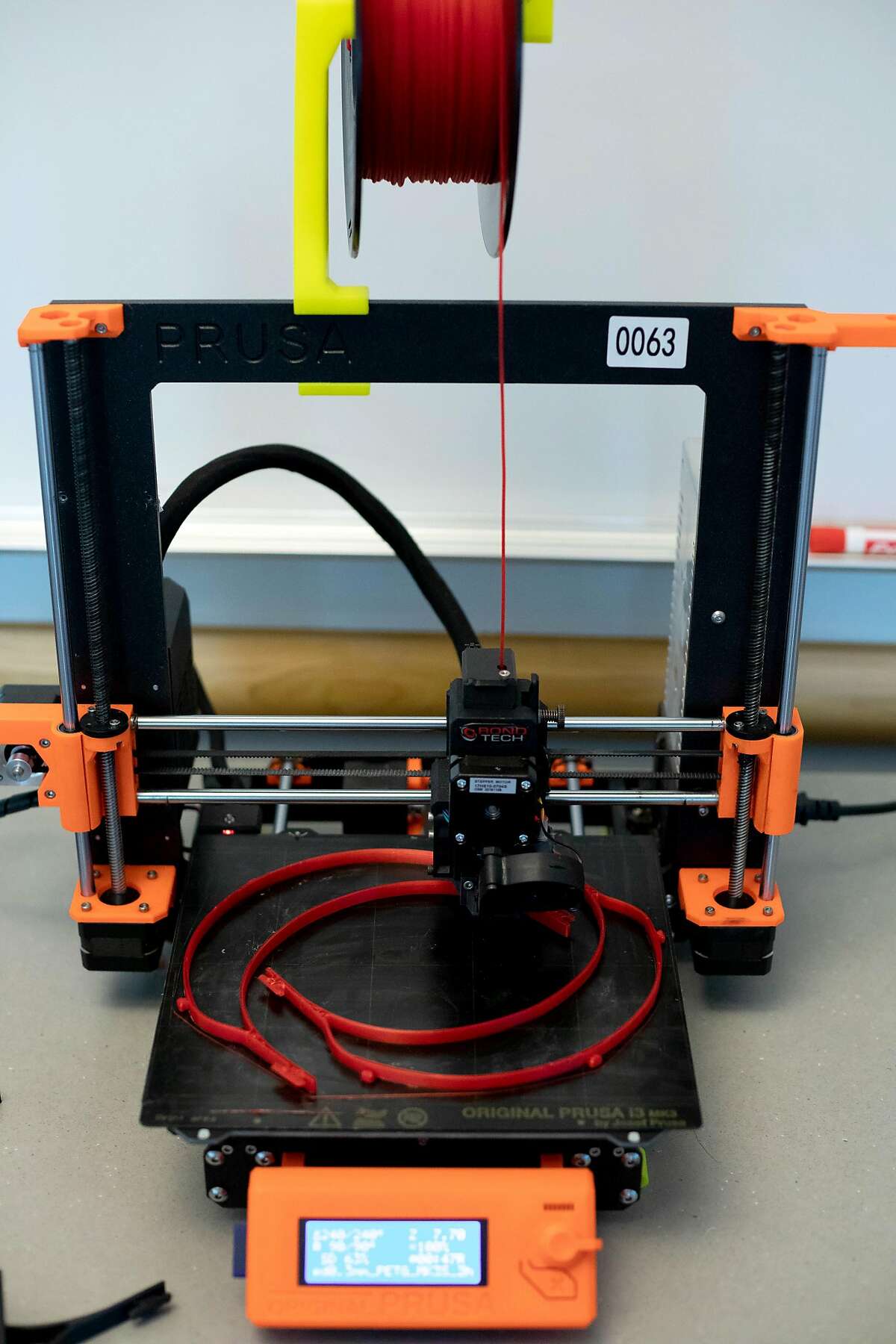 A 3D printer prints a headband made from PLA filament that will be used in a homemade face shield to offset shortages from the COVID-19 health crisis, at the Kalmanovitz Library, at the Parnassus campus.