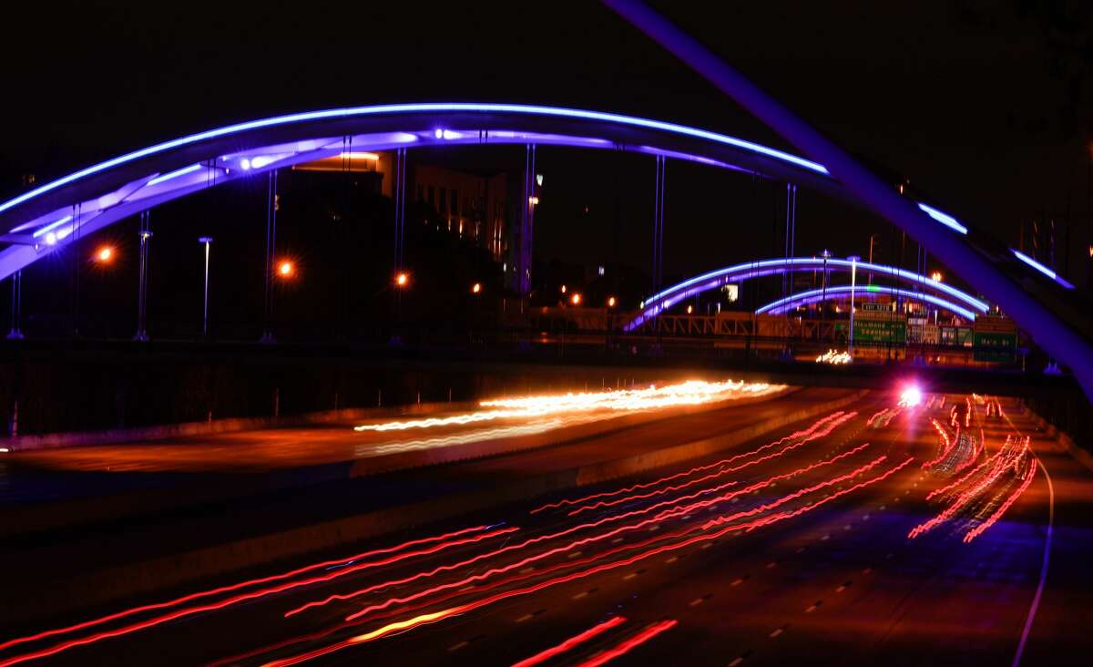 Traffic moves along I59 under blue lighted bridges shown from the Dunlavy bridge Thursday, April 9, 2020. Various Houston venues were lit blue as part of a nationwide #LightItBlue movement to honor essential workers on the front lines of the coronavirus pandemic.