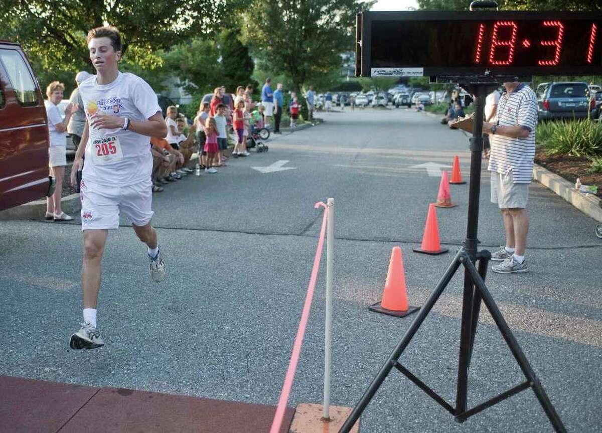 Ryan Heaney of Ridgefield, a Wake Forest student, wins the Amber Room Run from the Sun 5k race held at the Amber Room. Thursday, Aug. 20, 2010