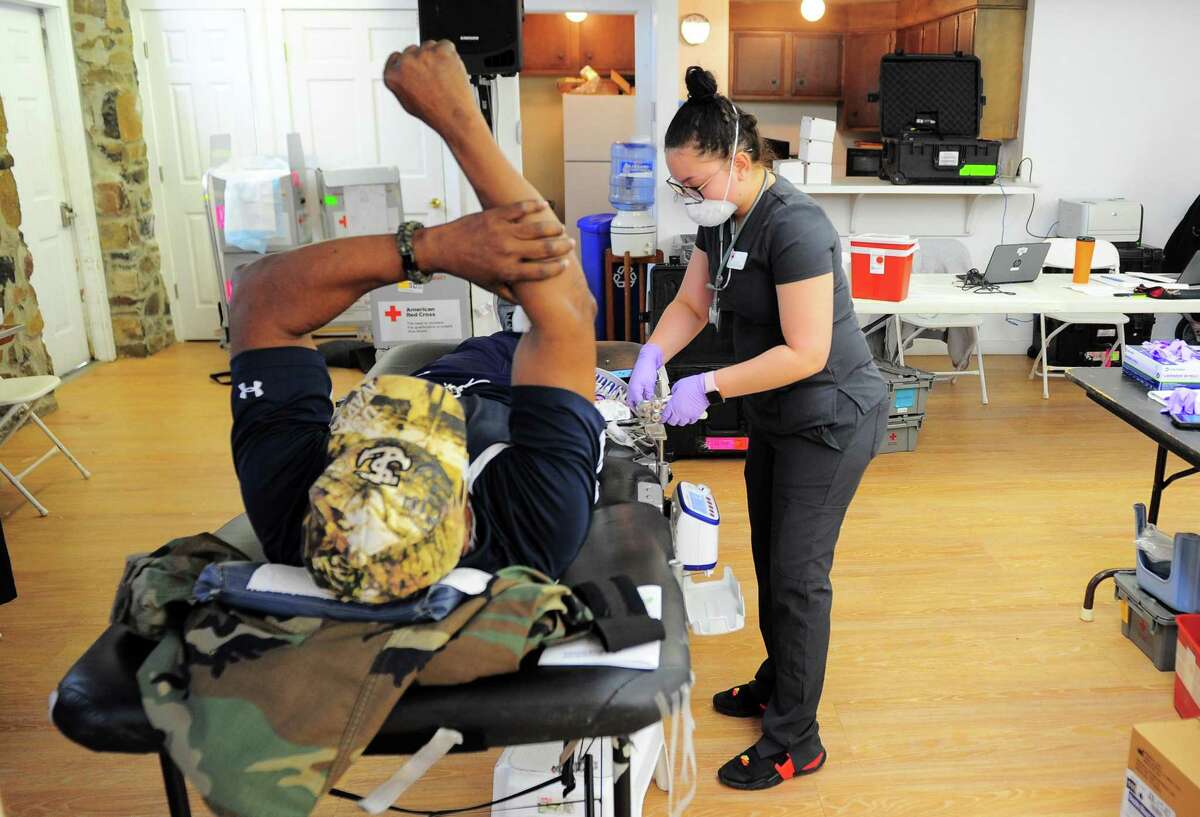 Collection Technician Jayla Ramos prepares donated blood during a American Red Cross blood drive at Whitneyville Cultural Commons in Hamden, Conn., on Friday Apr. 3, 2020. Due to the spread of the novel coronavirus, the American Red Cross has seen an uptick in donations.