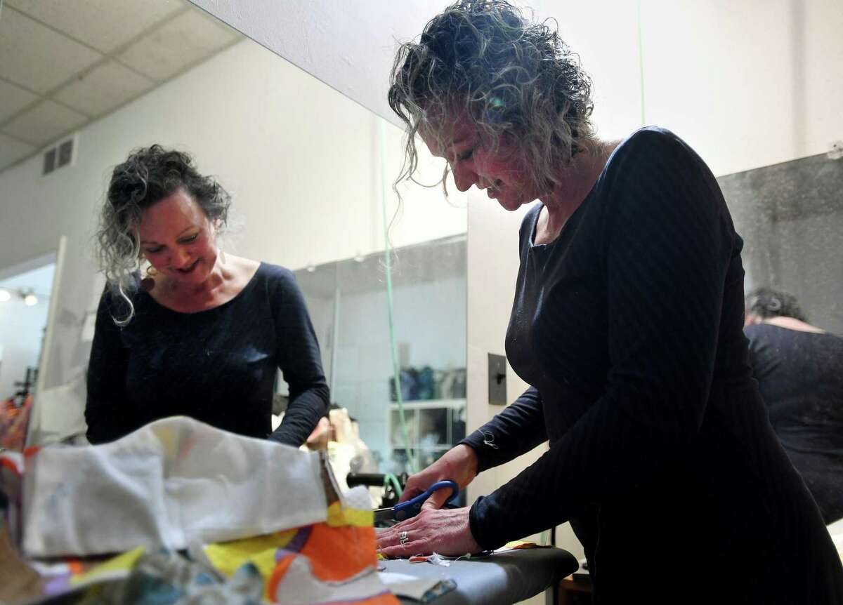 Fashion designer Jennifer Butler, of Fairfield, works on one of the over one hundred masks she has stitched for health care workers and others at her studio in Fairfield, Conn. on Sunday, April 5, 2020. Butler gives the masks away for free but has accepted donations to pay for fabric.