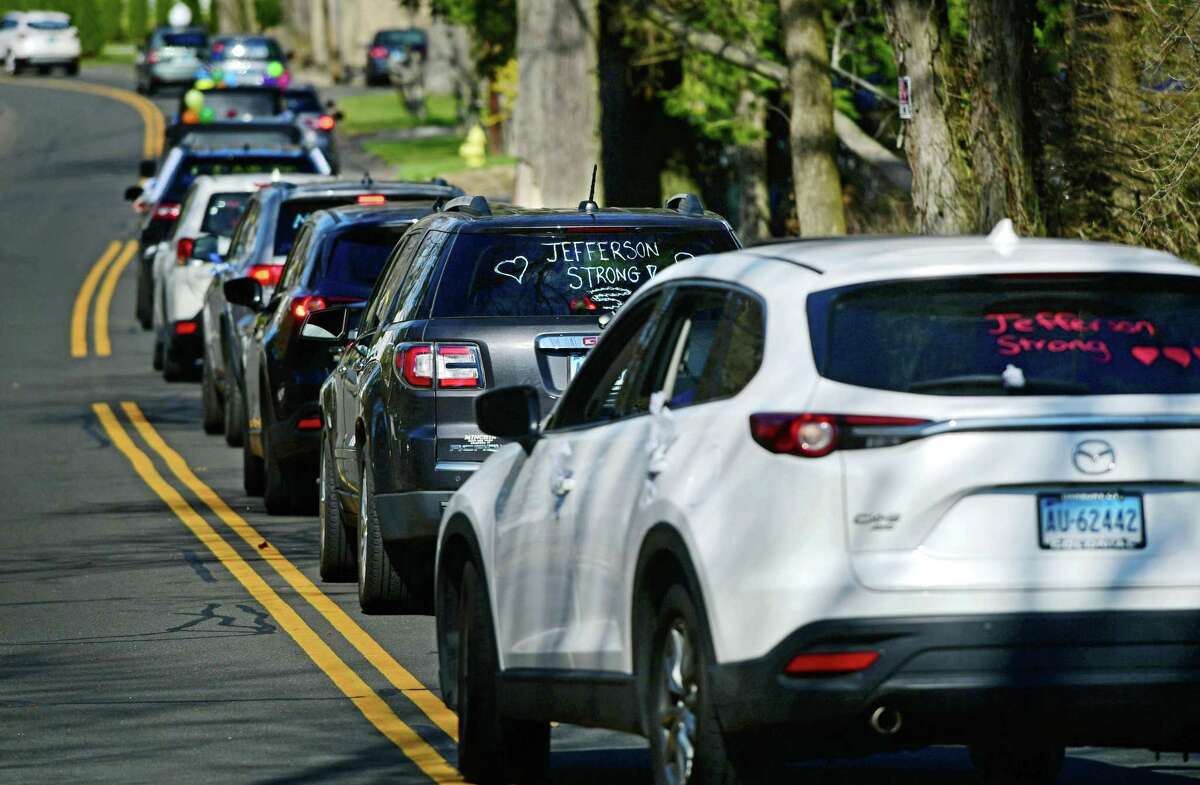 Jefferson Science Magnet School staff organized a motorcade which proceeds slowly by students' homes Thursday, April 2, 2020 as a way of rallying the neighborhood during the pandemic in Norwalk, Conn.