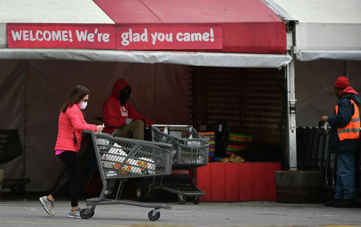 Shoppers exit Stew Leonards with groceries Tuesday, March 31, 20202, in Norwalk, Conn.