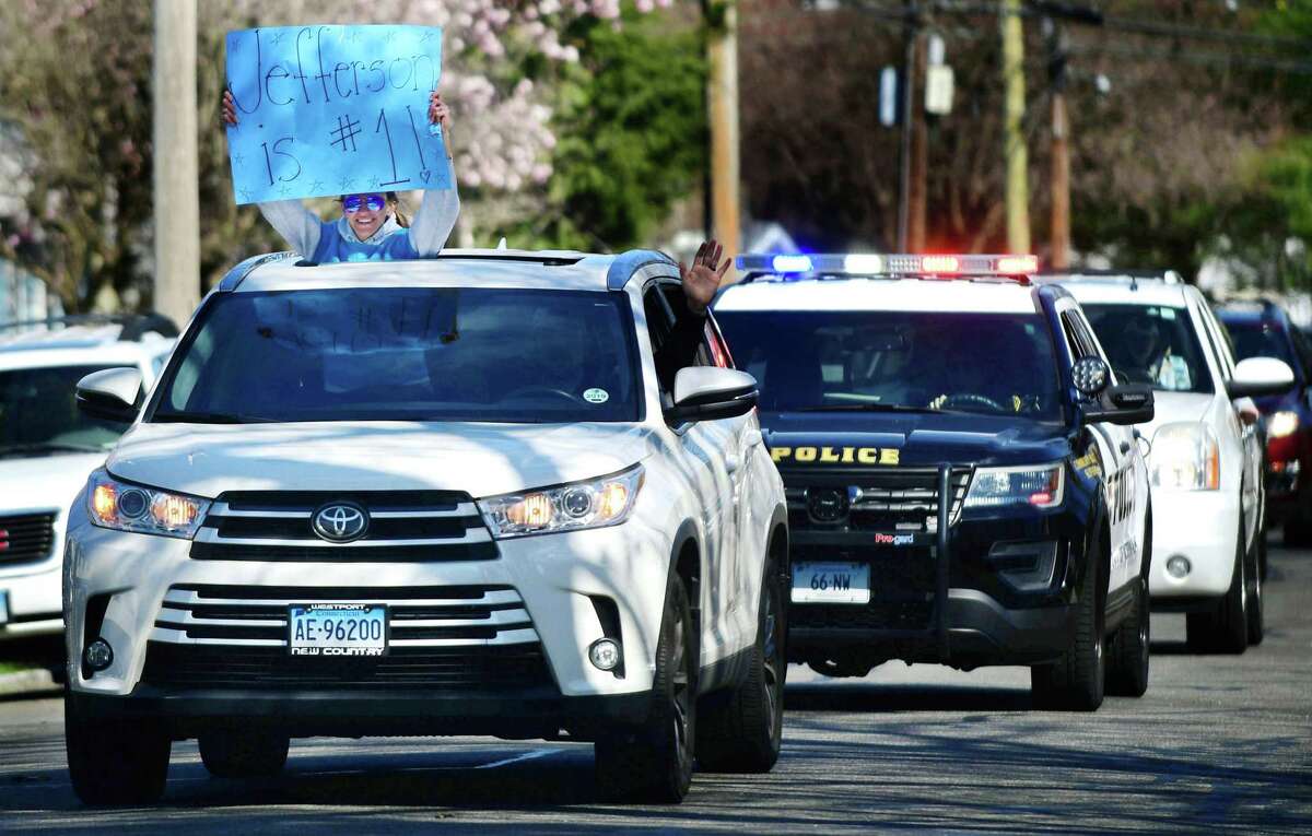 Jefferson Science Magnet School staff organized a motorcade which proceeds slowly by students' homes Thursday, April 2, 2020 as a way of rallying the neighborhood during the pandemic in Norwalk, Conn.