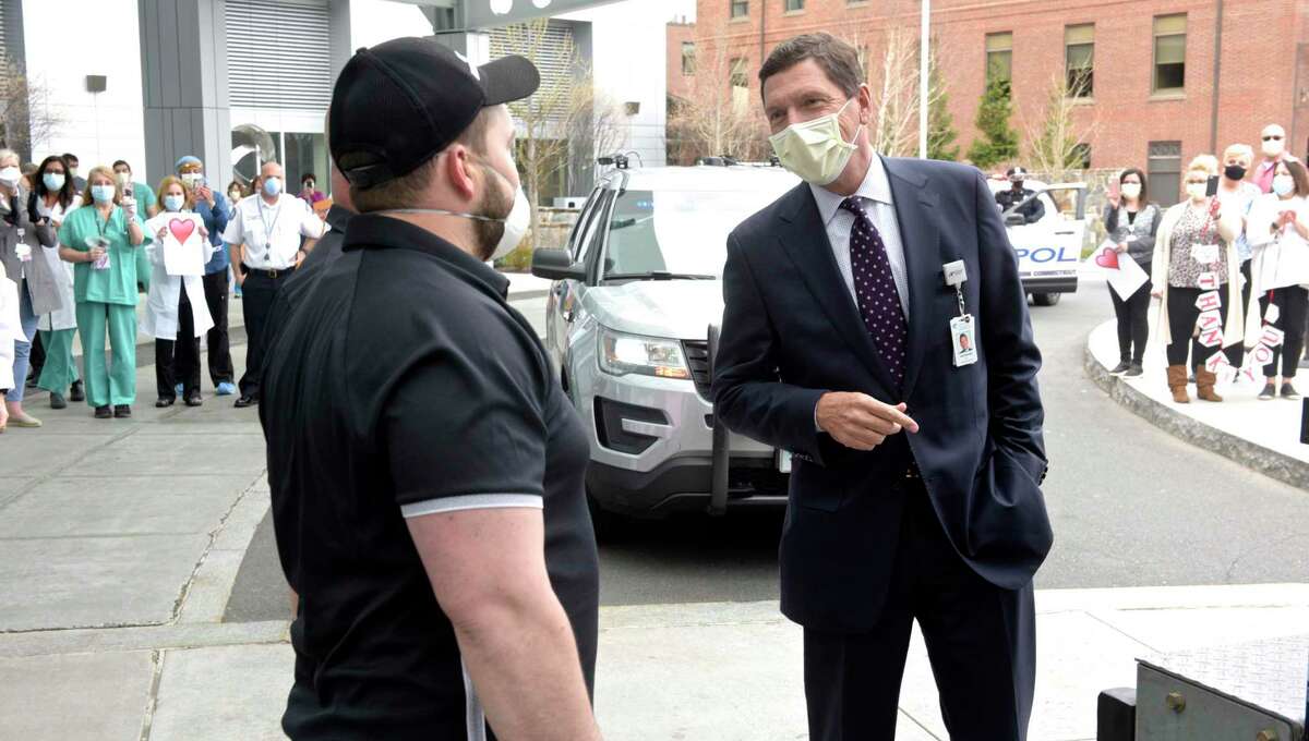 Ezra Zimmerman, of Ridgefield, owner of EZ Moving, talks with Dr John Murphy, President and CEO of Nuvance Health, at Danbury Hospital. Zimmerman volunteered to dive to Kentucky to pick up four used ventilators that the hospital had purchased. He was given a hero's welcome at the hospital and a police escort by state and local departments from I-84. Tuesday, April 7, 2020, in Danbury, Conn.