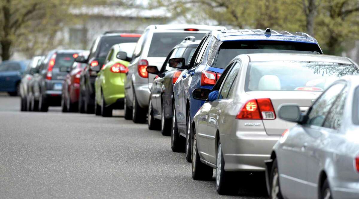 Cars wait in line as Faith Church started its "Manna from Heaven" program on Wednesday evening. The church was distributing 250 hot meals each week to people in need. The meals are being purchased from four local restaurants, which also helps those establishments. Wednesday, April 8, 2020, in New Milford, Conn.