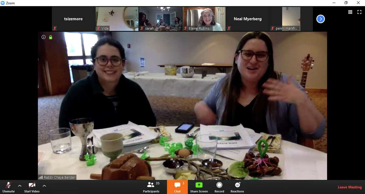 Rabbi Chaya Bender, right, accompanied by her wife, Emily Jaeger, lead the Temple Sholom seder on a Zoom meeting attended by many other Temple Sholom congregants. Celebrating the start of Passover, the seder dinner featured interactive questions, singalongs, and seder-themed hats. More than 50 families attended the online meetup, allowing for a sense of community and togetherness in a time of social distancing and isolation.