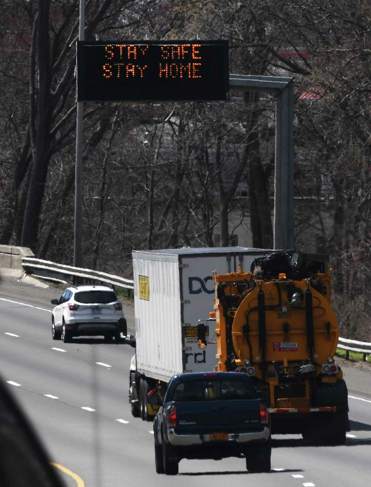 A sign reading "Stay safe, stay home" flashes above the southbound lane of I-95 between Exit 5 and Exit 6 at the border of Greenwich and Stamford, Conn. Thursday, April 2, 2020.