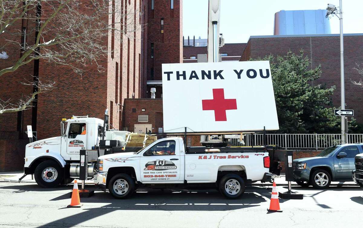 Kyle DeLucia, founder and owner of K&J Tree Service, put up a 50 foot United States flag and a large thank you across from the hospital on York Street to show his appreciation for the work of the staff of Yale New Haven Hospital on April 6, 2020.