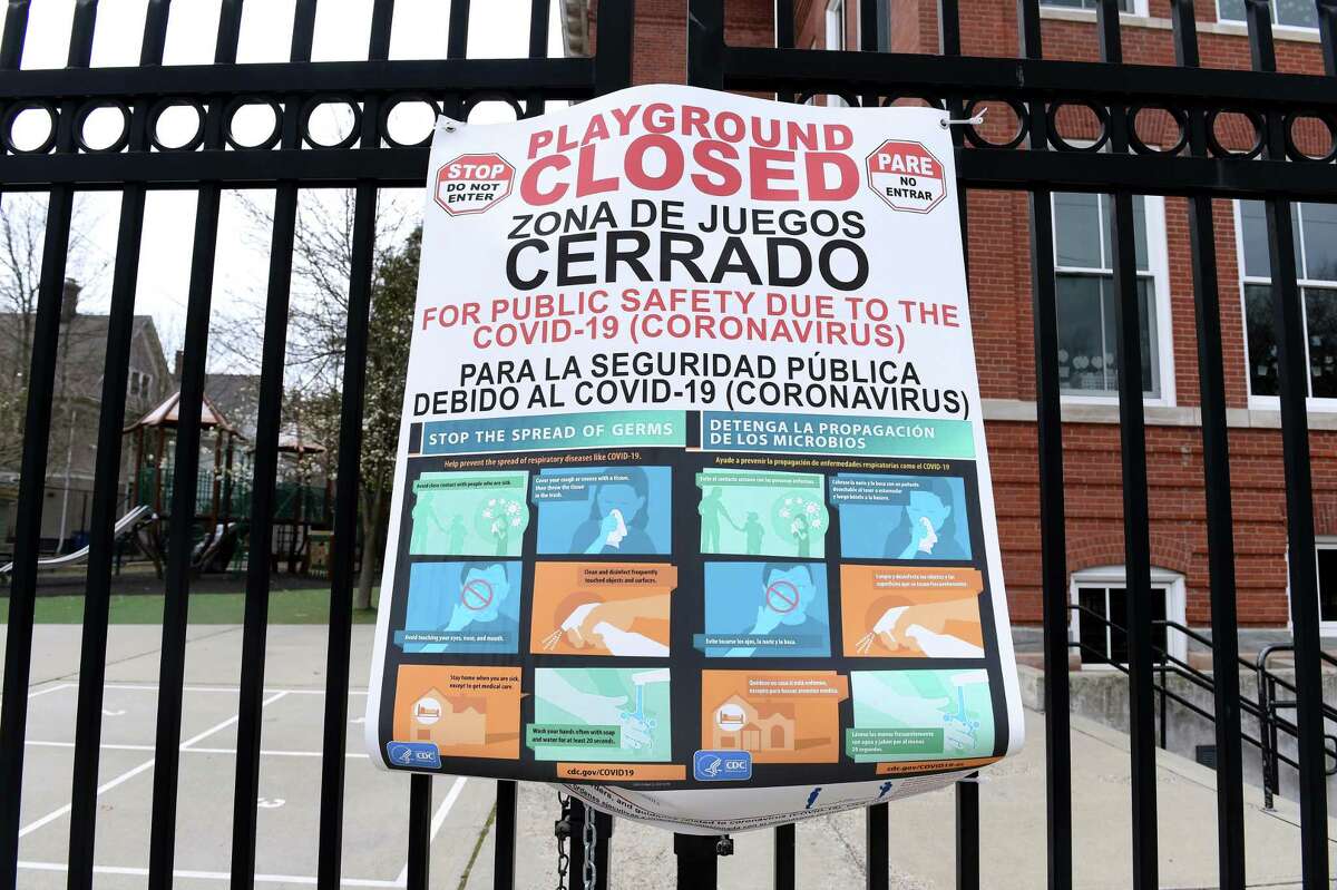 A closed sign hangs from a locked gate to the playground at Worthington Hooker School in New Haven on April 5, 2020.