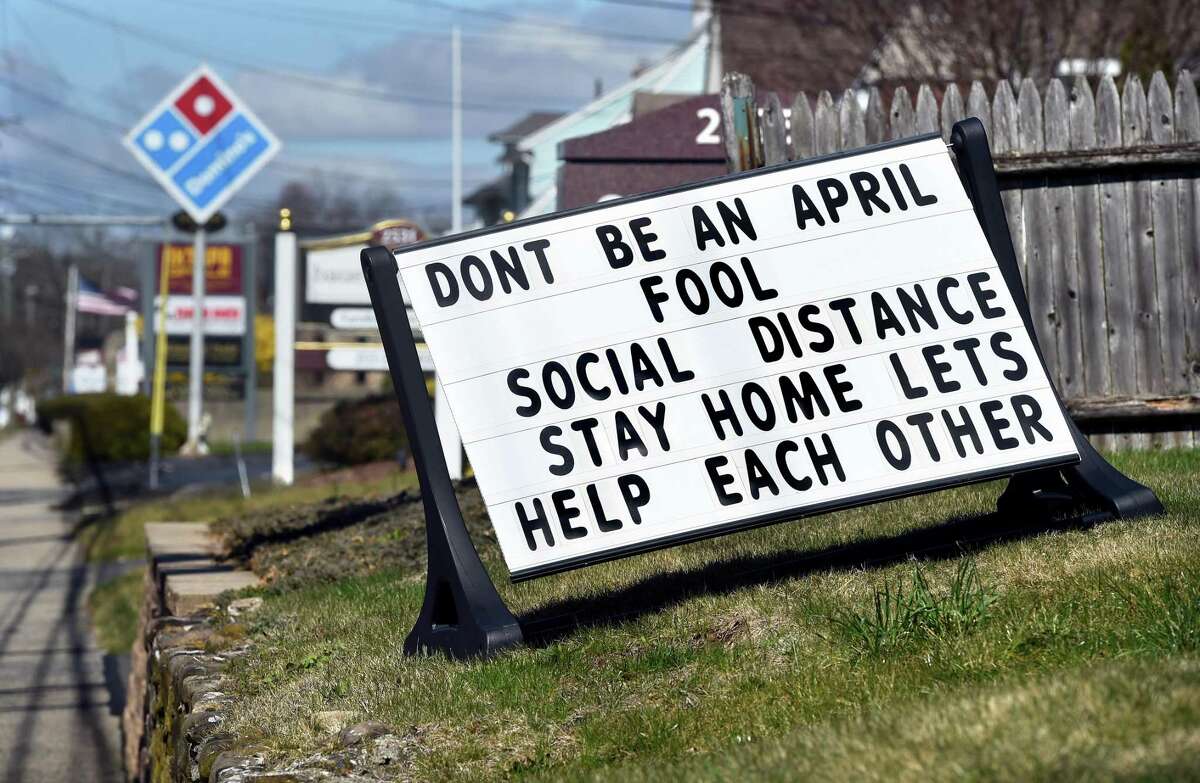 A sign promoting social distancing is displayed on Whitney Avenue in Hamden on April 4, 2020.