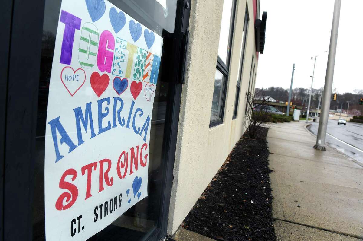 An inspirational message is displayed at the entrance to a State Farm office in Ansonia on April 3, 2020.