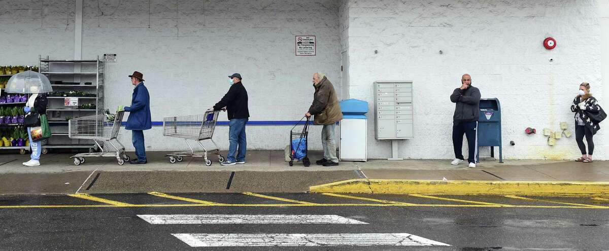 Shoppers maintain social distancing as they wait in line to enter ShopRite in Derby on April 3, 2020.