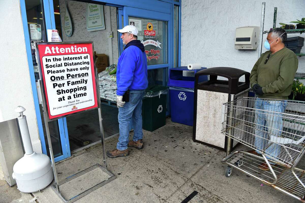 Frozen Food Manager Carl Paternoster (center) monitors and regulates shoppers waiting in line to enter ShopRite in Derby on April 3, 2020.