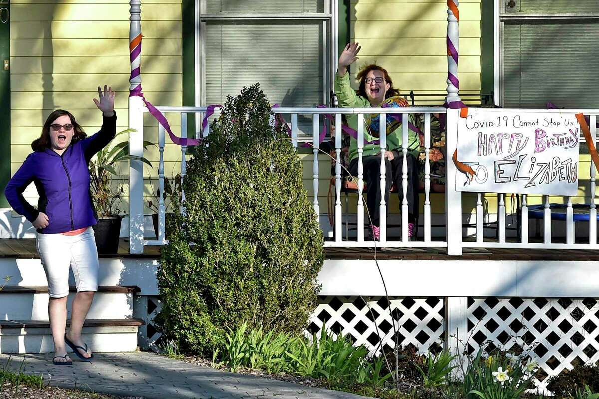 Orange, Connecticut - Monday, April 06, 2020: A surprise parade of cars slowly drive by the Orange home of Elizabeth Romanovsky, 15, celebrating her 15th birthday Monday in lieu of a party to comply with the social distancing protocol during the Coronavirus / Covid-19 pandemic.