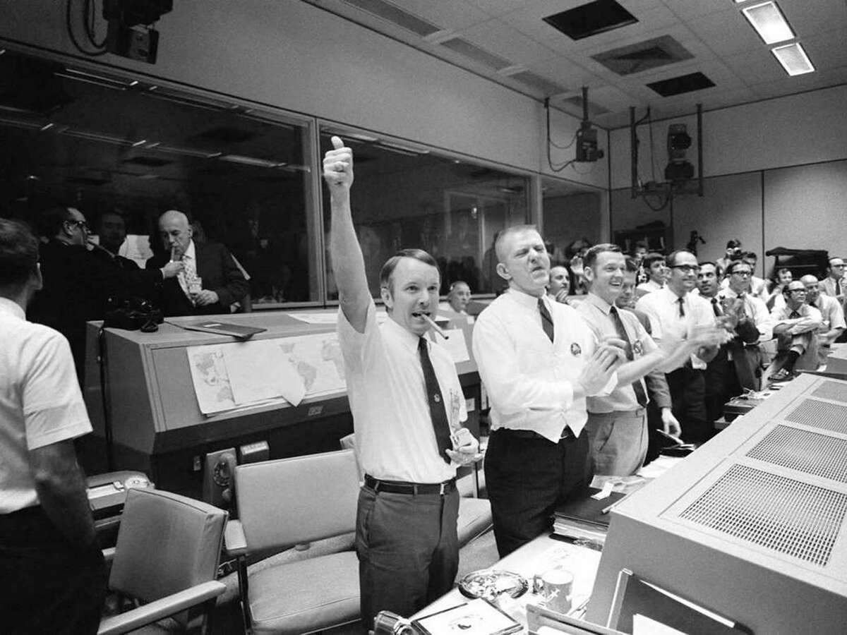 Three of the four Apollo 13 flight directors applaud the successful splashdown of the Command Module "Odyssey" while Dr. Robert R. Gilruth, director, Manned Spacecraft Center, and Dr. Christopher C. Kraft Jr., deputy director, light up cigars (upper left). The flight directors are, from left to right: Gerald D. Griffin, Eugene F. Kranz and Glynn S. Lunney.