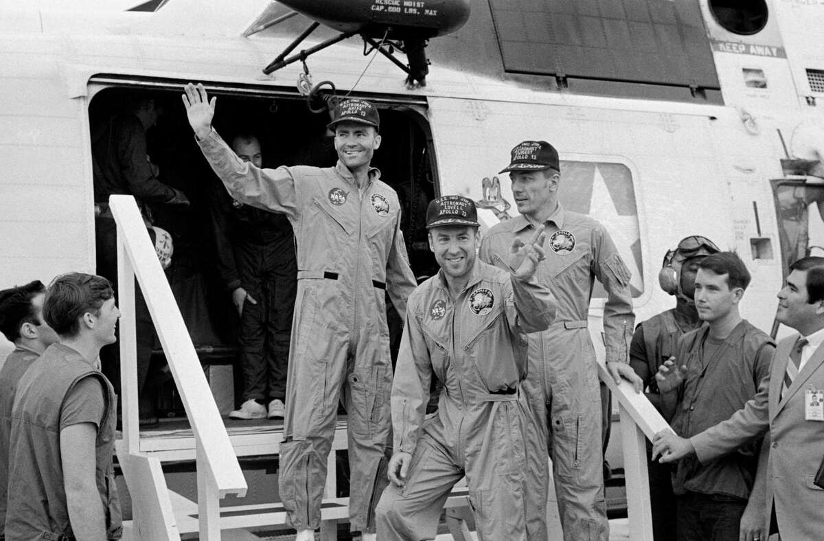The crewmembers of the Apollo 13 mission, step aboard the USS Iwo Jima, prime recovery ship for the mission, following splashdown and recovery operations in the South Pacific Ocean. Exiting the helicopter which made the pick-up some four miles from the USS Iwo Jima are (from left) astronauts Fred W. Haise Jr., lunar module pilot; James A. Lovell Jr., commander; and John L. Swigert Jr., command module pilot. The crippled Apollo 13 spacecraft splashed down April 17, 1970.