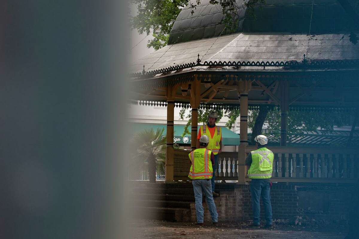 Workers confer under the bandstand at Alamo Plaza in downtown San Antonio on Thursday. The bandstand will be disassembled and moved into storage. It will be relocated to a city park in the near future. Councilman Roberto Treviño said several neighborhoods have expressed interest in providing a home for the bandstand, which dates to the 1970s and is similar to one built in the 1800s.