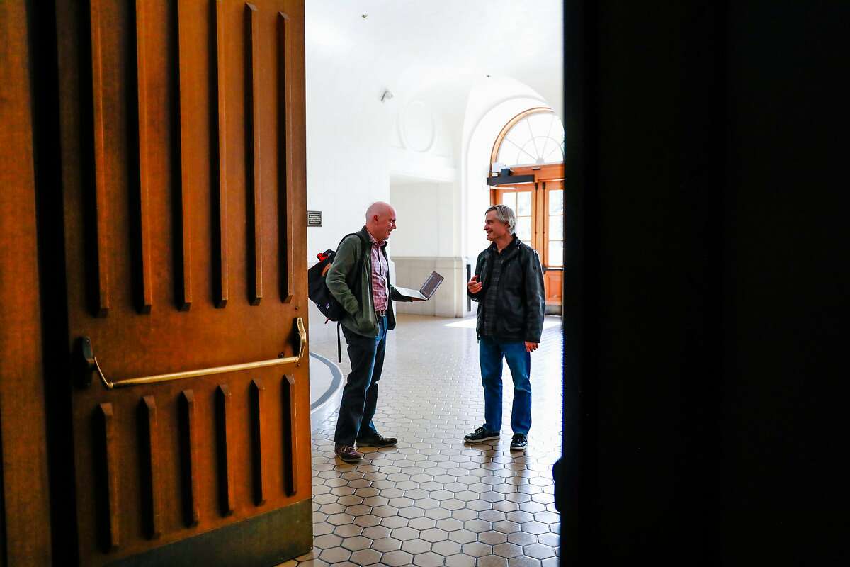 Jon Hays and Ezra Daly (right) who work in IT prepare to get classes up on the web so students can access them remotely at UC Berkeley on Tuesday, March 10, 2020 in Berkeley, California. UC Berkeley has suspended in-person classes through the end of Spring break due to the coronavirus.