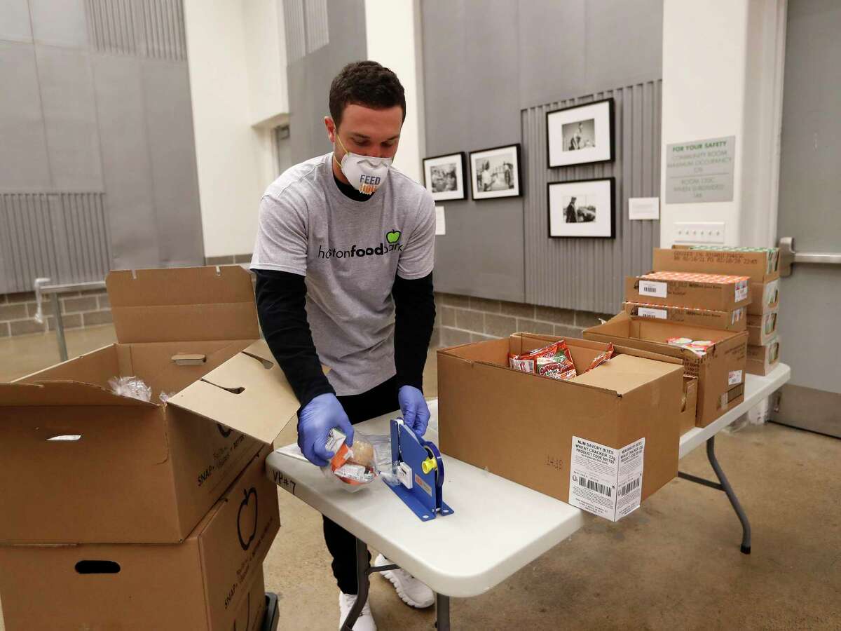 Houston Astros Alex Bregman packaging sustainable kids meals at the Houston Food Bank, in Houston,Friday, April 10, 2020. Bregman launched his FEEDHOU, a $1 million fundraising campaign to help feed Houston-area residents during the coronavirus pandemic.