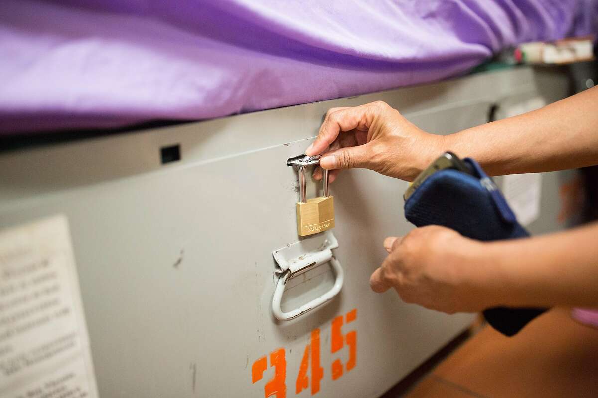 Irene Duldulao locks her belongings up in her assigned locker at St. Vincent De Paul Society Multi Service Center on (MSC South) on Tuesday, June 18, 2019 at 7:32pm on 5th St and Bryant St in San Francisco, Calif.
