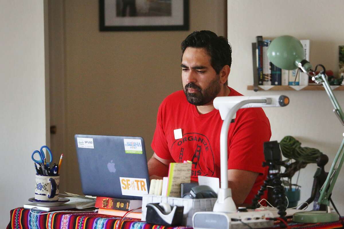 Frank Lara, fifth grade bilingual teacher at Buena Vista Horace Mann and member of United Educators of San Francisco, works at a desk that he set up at his home after the the coronavirus shelter in place on Friday, April 10, 2020 in South San Francisco, Calif.