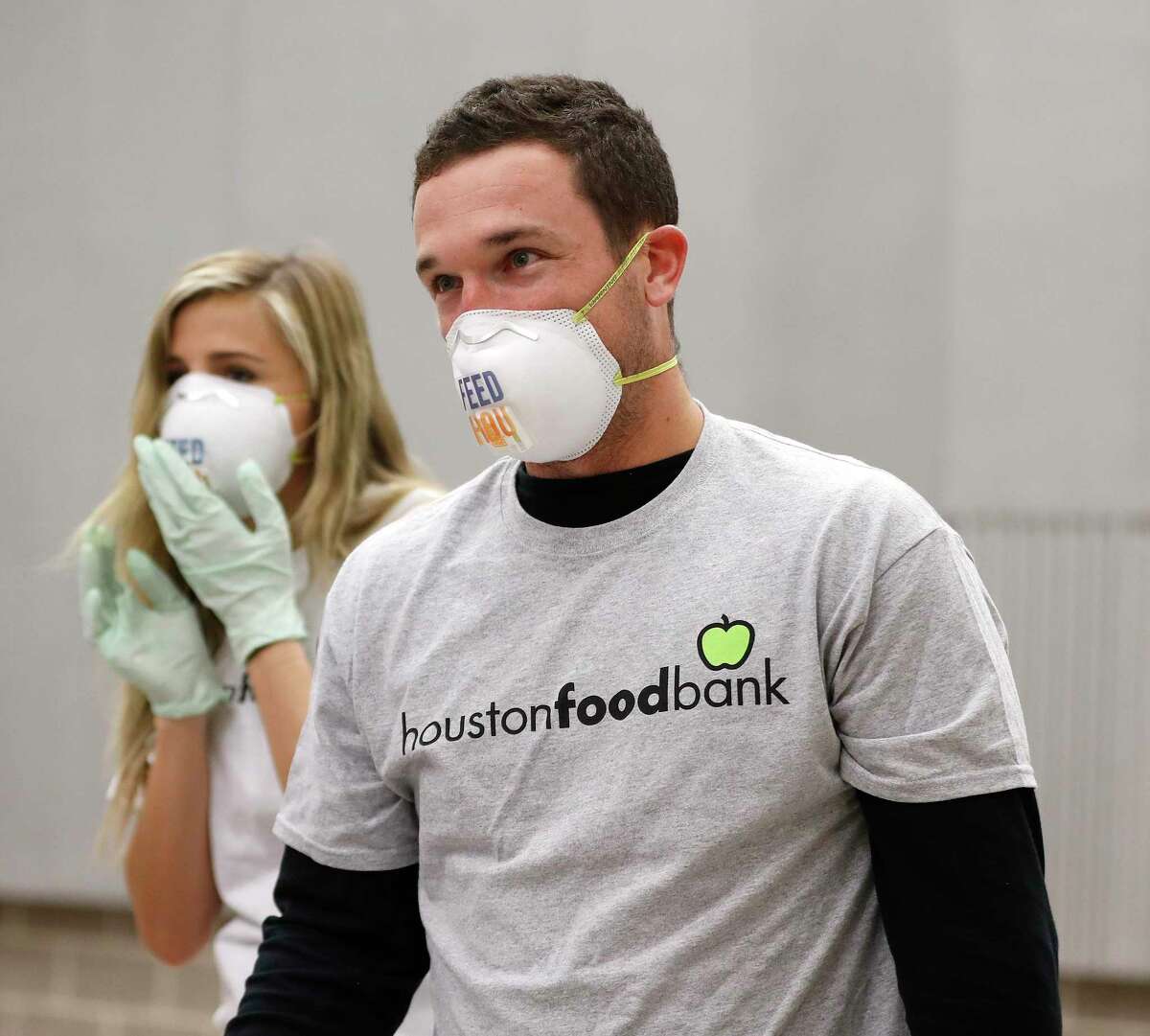 Houston Astros Alex Bregman and his fiancee, Reagan Howard prepare to start packaging sustainable kids meals at the Houston Food Bank, in Houston,Friday, April 10, 2020. Bregman launched his FEEDHOU, a $1 million fundraising campaign to help feed Houston-area residents during the coronavirus pandemic.