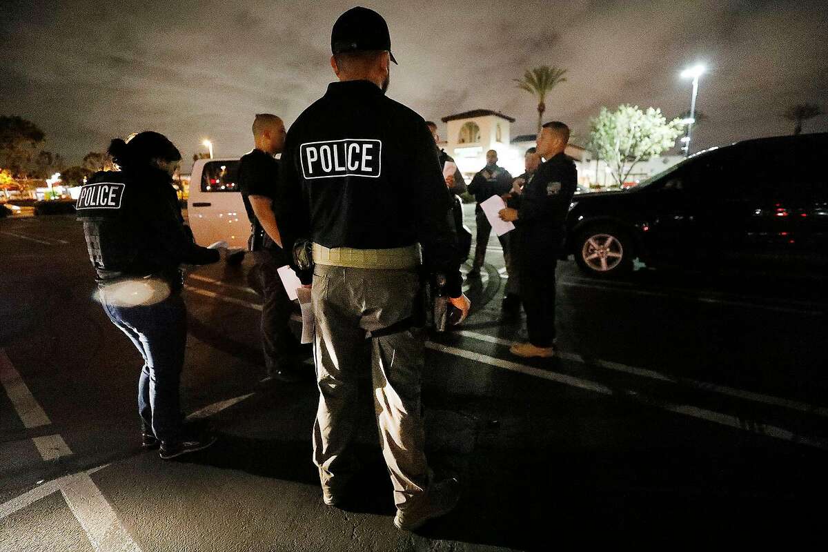 David A. Marin, right, Field Office Director Enforcement and Removal Operations Los Angeles Field Office of U.S. Immigration and Customs Enforcement officers during a pre-dawn briefing before apprehensions are made in Bell Gardens, Calif., on March 16, 2020. (Al Seib/Los Angeles Times/TNS)
