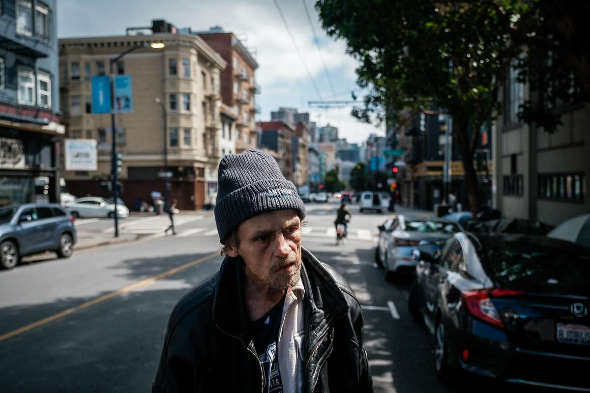 Jeff Reaves, a homeless man, pauses on the street while walking to his tent in the tenderloin on Friday April 10, 2020.