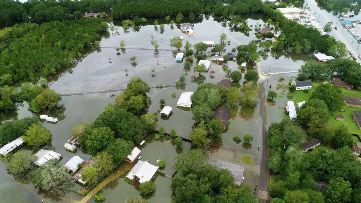 Flood waters from Tropical Storm Imelda surround Fannett homes near Texas 124 on Friday. Photo taken Friday, 9/20/19