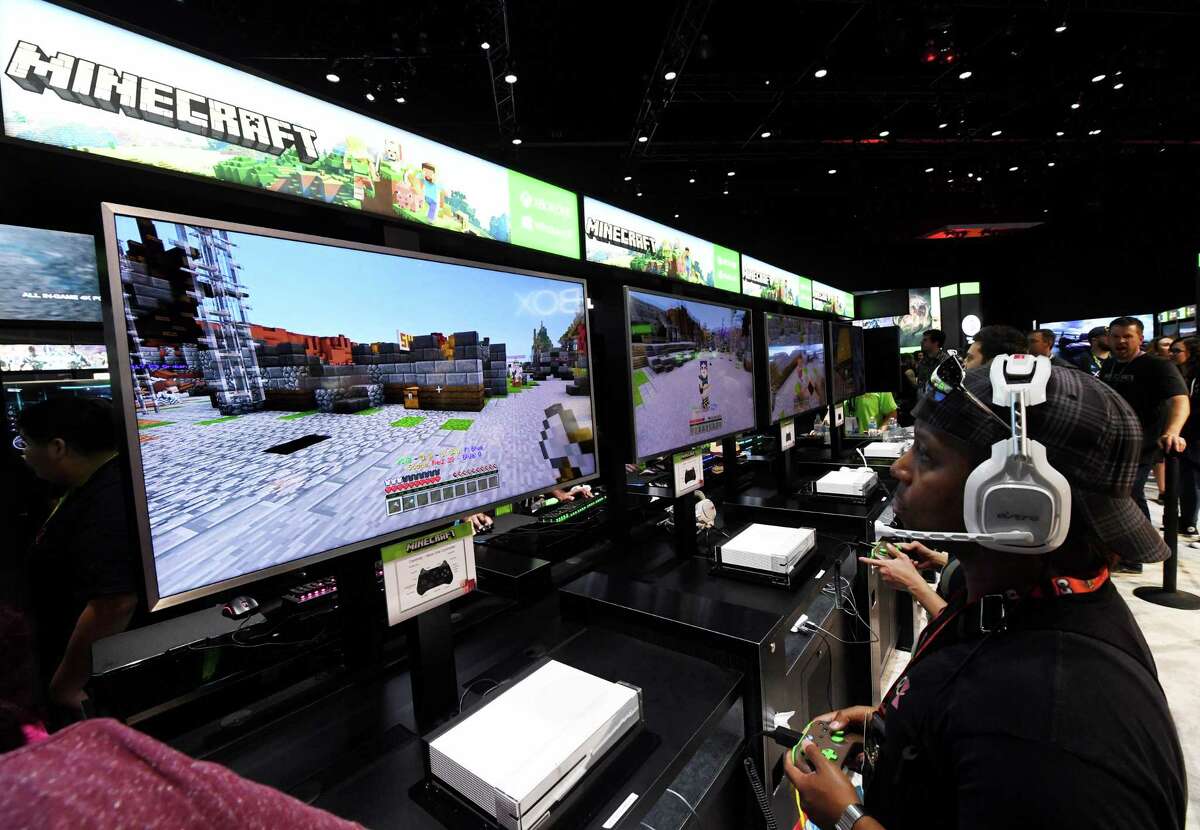Gamers in the Microsoft Xbox exhibit play the "Minecraft" game at the Los Angeles Convention center on day one of E3 2017, the three day Electronic Entertainment Expo, one of the biggest events in the gaming industry calendar, in Los Angeles, California on June 13, 2017. / AFP PHOTO / Mark RALSTONMARK RALSTON/AFP/Getty Images