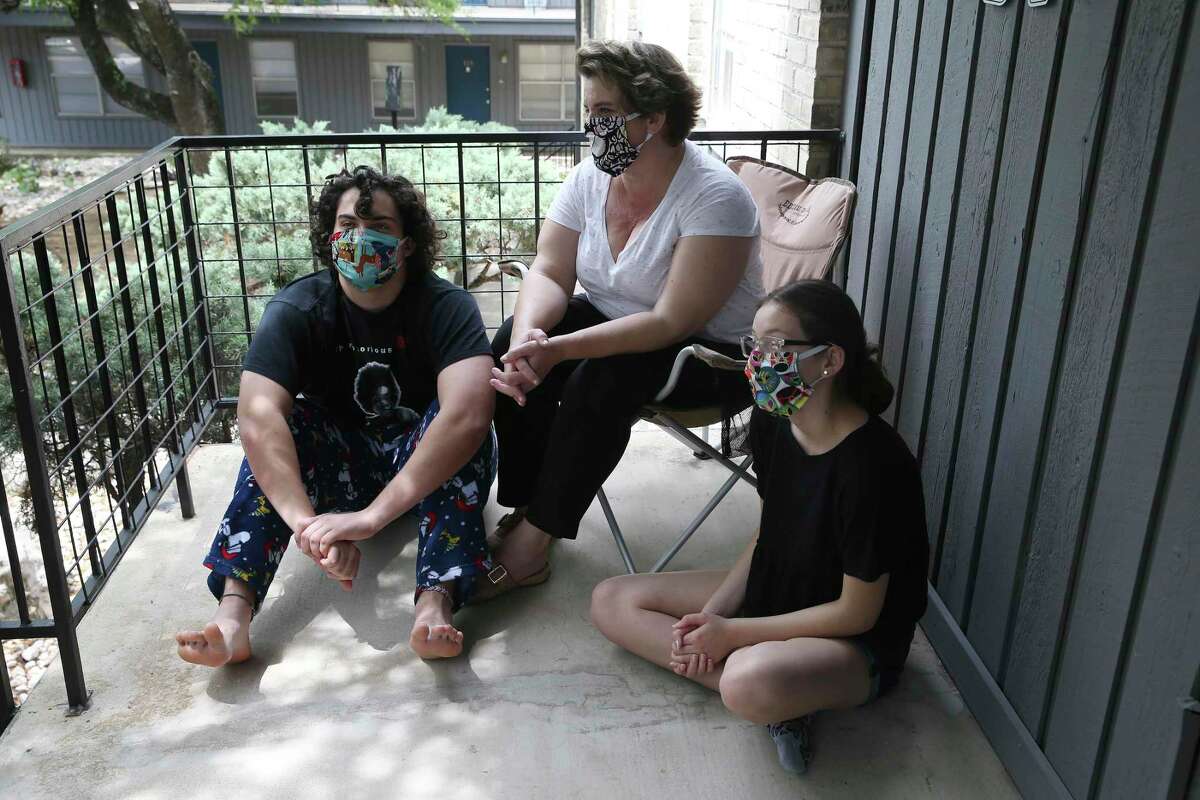 Melissa Harnish and her children get a little fresh air on their apartment balcony.