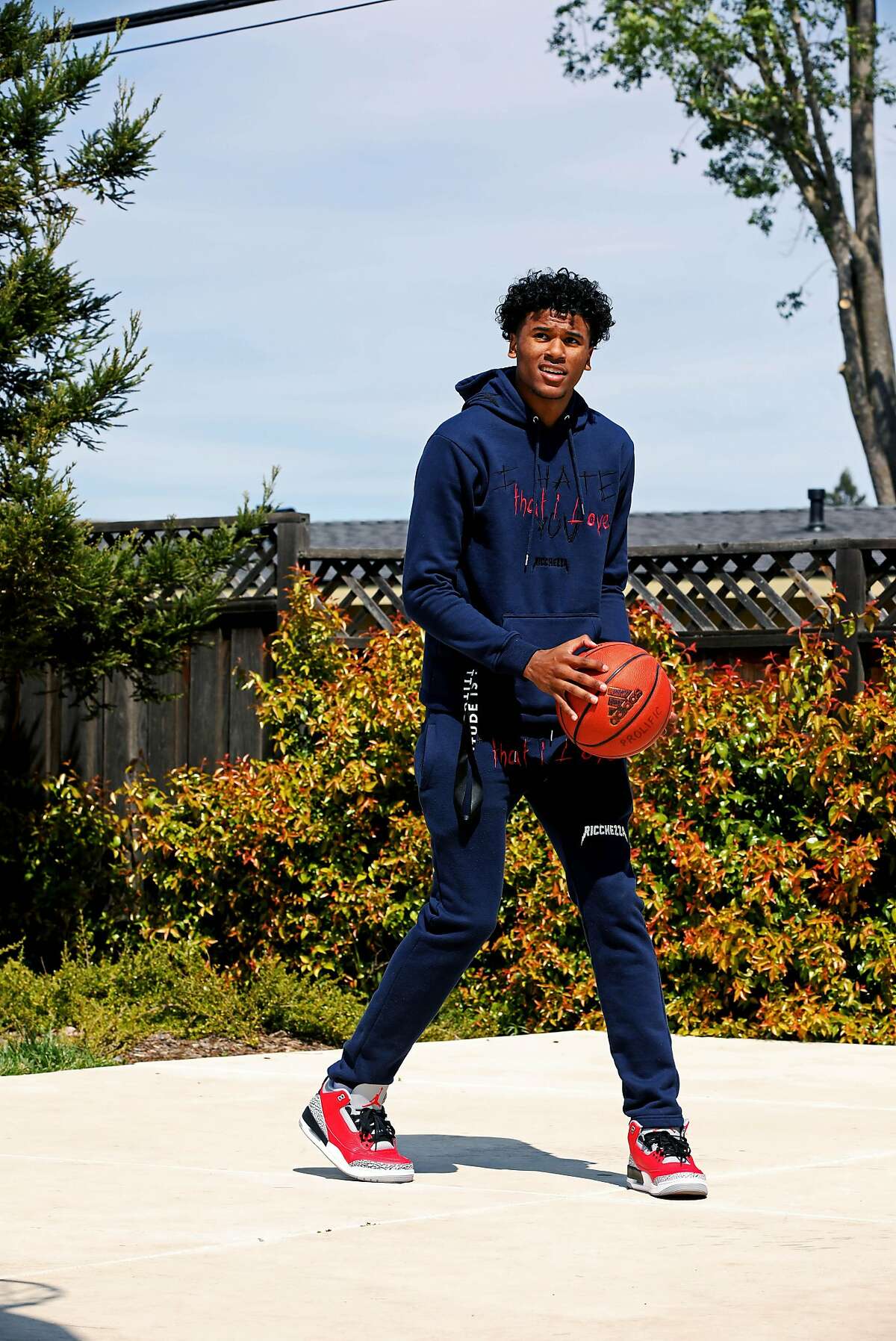 High School basketball star Jalen Green, 18, shoots a basket in his neighborhood on Friday, March 27, 2020, in Napa, Calif. The 6'6" guard is expected to be the No. 1 men's basketball recruit in the 2020 class.