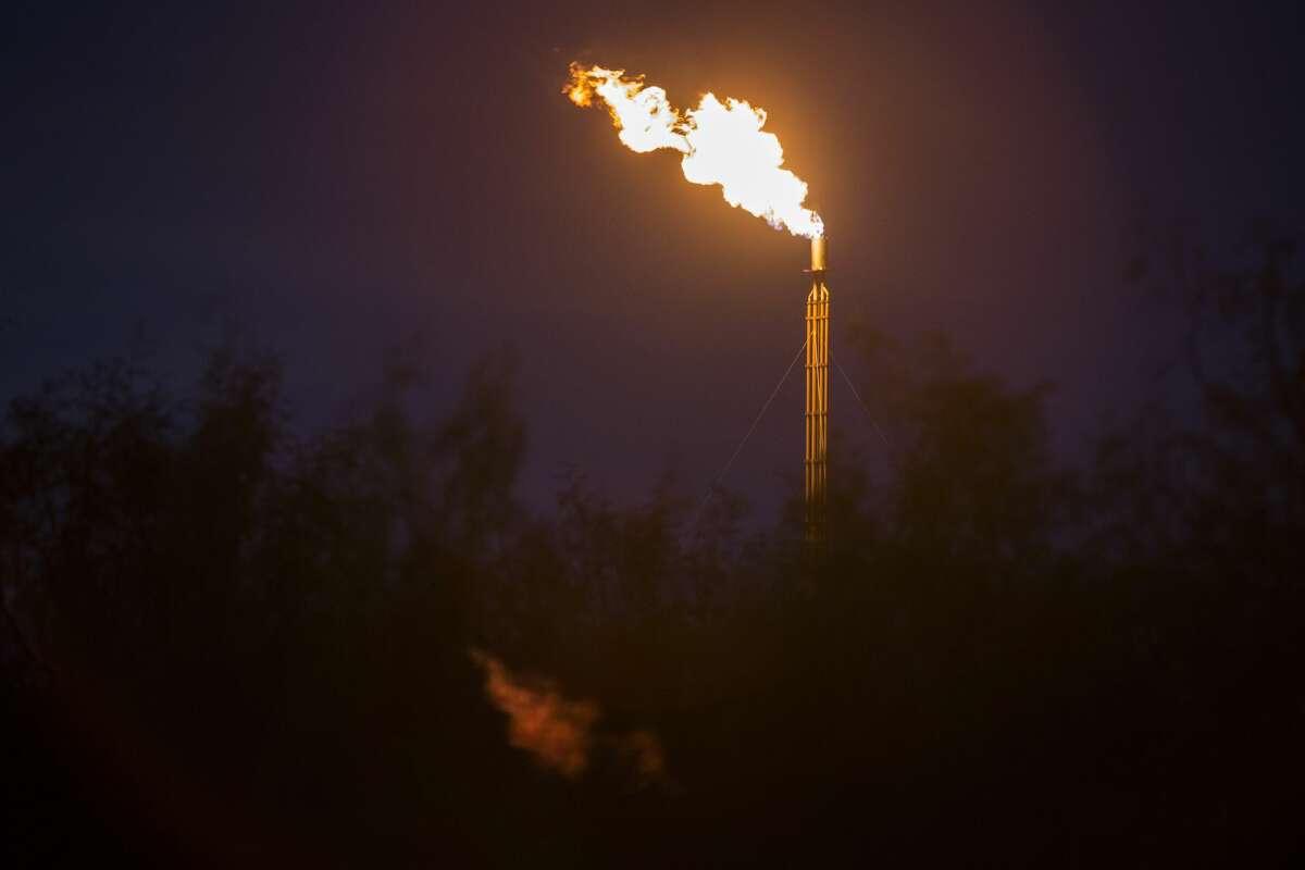 A flare from an oil rig is seen in Balmoreah on Wednesday, August 17, 2016. The rise of fracking nearby the town has some community members worried about their drinking water and natural springs, which serve as a popular tourism destination helping drive the town's economy.