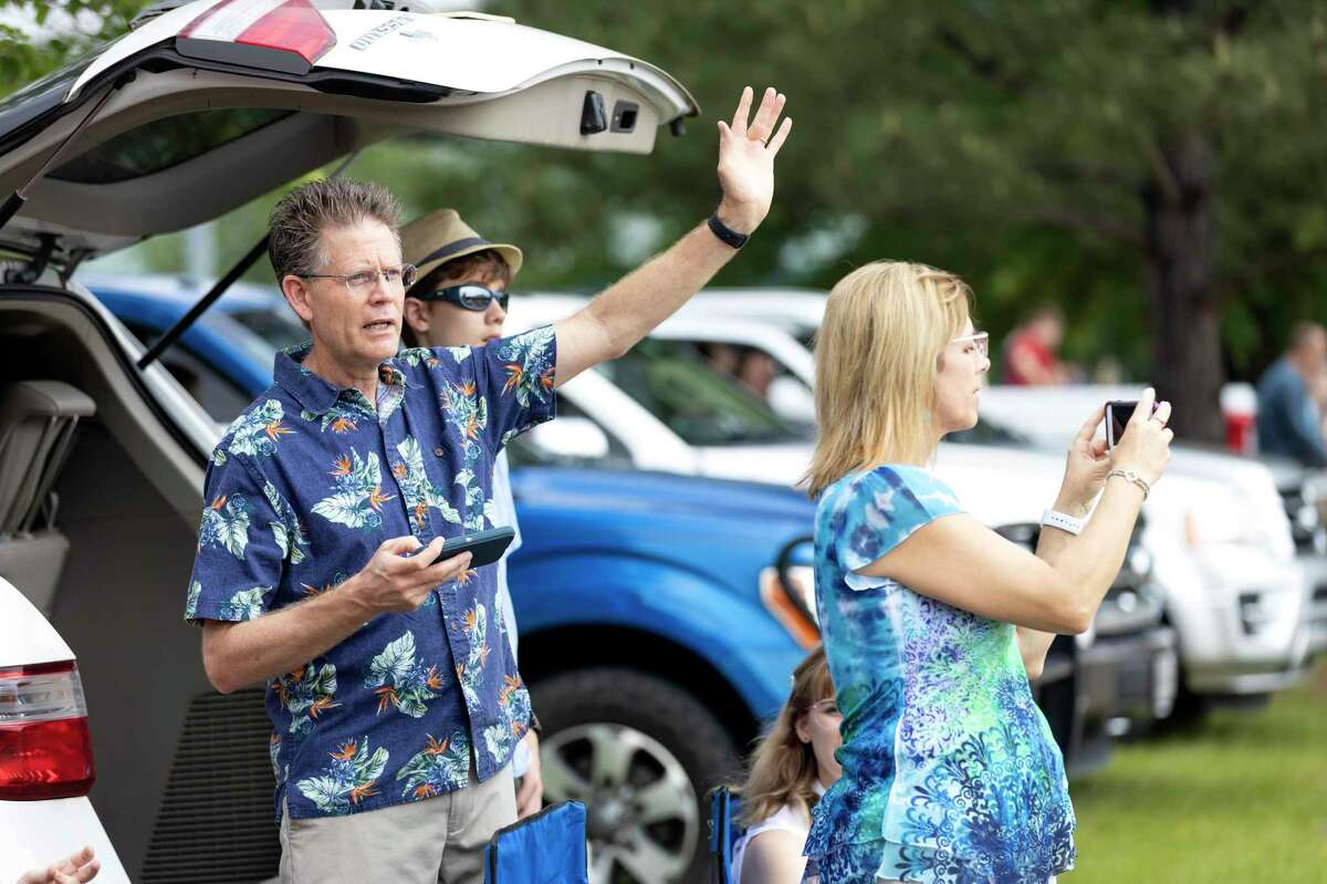Roger and Sara Derksen listen to a sermon by Senior Pastor Dave Schneider at Conroe Bible Church, Sunday, April 12, 2020. Easter services were held in a drive-in style service where parishioners stayed in their vehicles due to COVID-19.