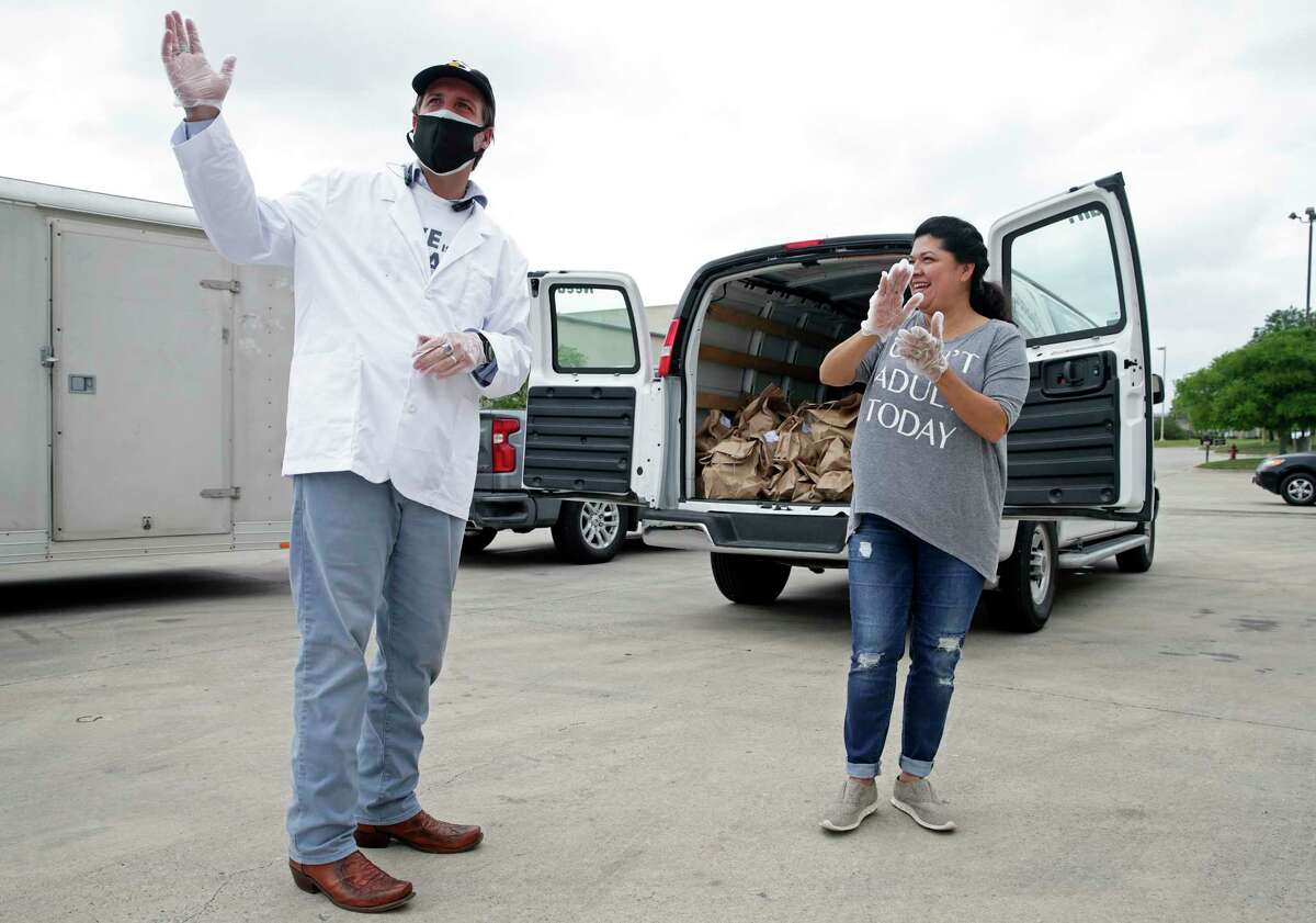 Luciano Ciorciari acknowledges appreciation after he loads a truck for Elizabeth Lutz of the Health Collaborative as he rallies his employees at his Food Related headquarters in Schertz to assemble 400 Drop Off food deliveries on April 10, 2020.