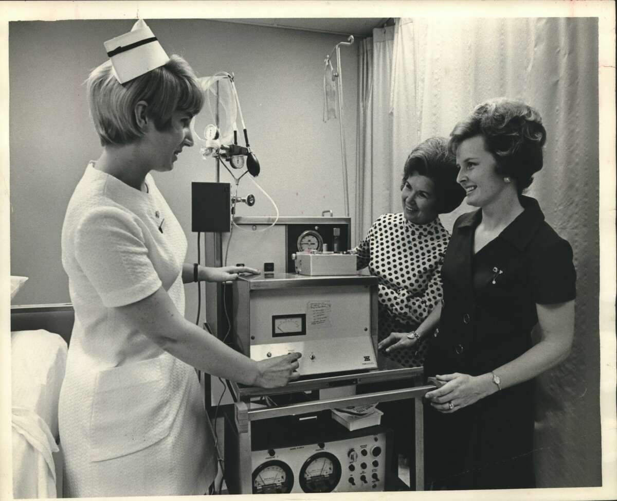 Left to right: Mrs. Mary Gay, R. N.; Mrs. Ray Roman and Mrs. Janice Clark. Kidney machines. Nurse Mrs. Mary Gay at Methodist Hospital shows a kidney machine to visiting Epsilon Sigma Alpha members Mrs. Ray Roman, center and Mrs. Janice Clark. Proceeds from the sorority's annual Charity Ball Saturday, February 19, at the Rice Hotel will be used by the kidney Foundation of Houston and the greater Gulf Coast to purchase one of the life-saving machines. Dick Gottlieb will be master of ceremonies at the gala ball, set from 9 p.m. to 1 a.m. in the Grand Ballroom. The Phil Gray Orchestra will entertain. Mrs. Roman is Epsilon Sigma Alpha president and Mrs. Clark is ball chairman.