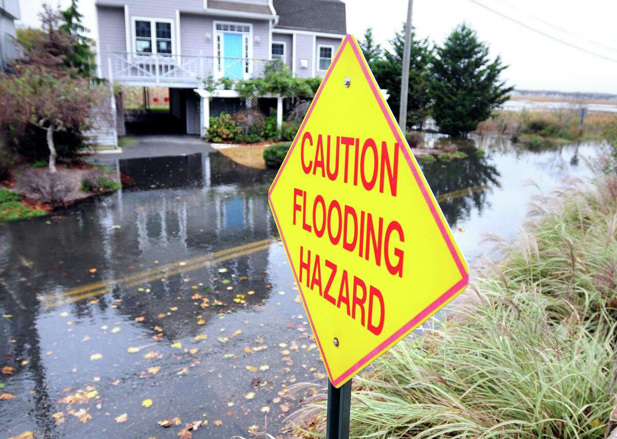 Flooding covers Milford Point Road in Milford as high tide approaches on Oct. 29, 2012. Heavy rains and high winds could bring flooding to the same area on Monday, April 13, 2020.