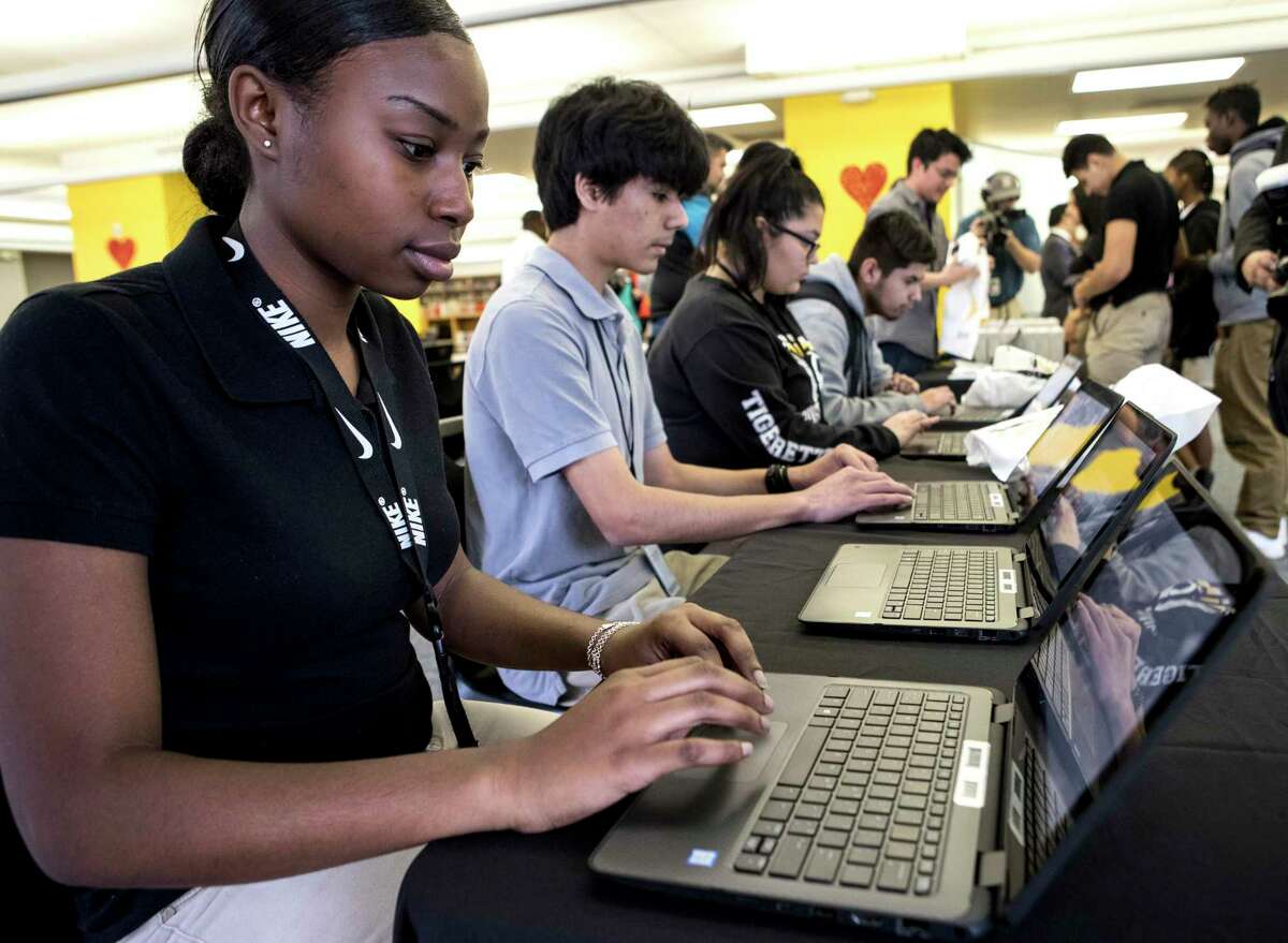 In this 2018 file photo, Bre'Nira Fuller takes a survey on a laptop after receiving her new Sprint wireless internet hotspot device provided by the 1Million Project Foundation at Houston ISD’s Sam Houston Math, Science & Technology Center. While many high school students already use hotspots in HISD, district officials are trying to buy more devices for students in lower grades during the novel coronavirus pandemic.