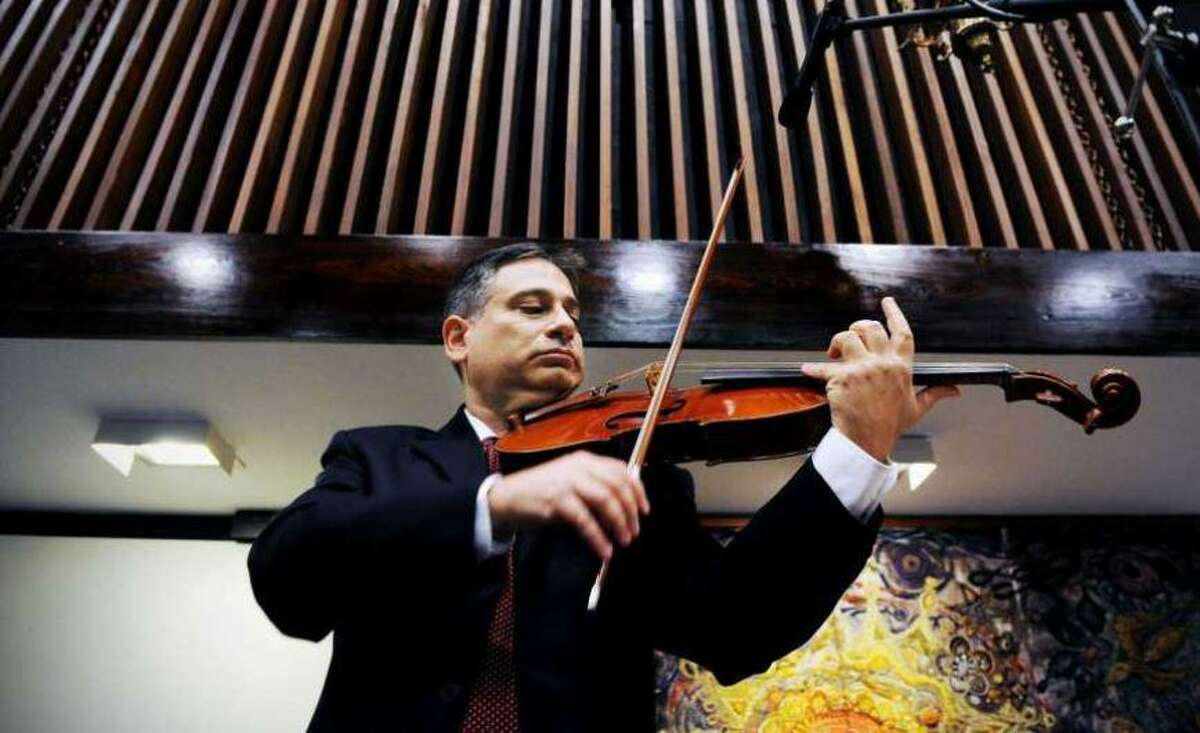 Vincent Lionti plays the viola at Temple Sinai in North Stamford in 2010, where he ad performed for more than 35 years.