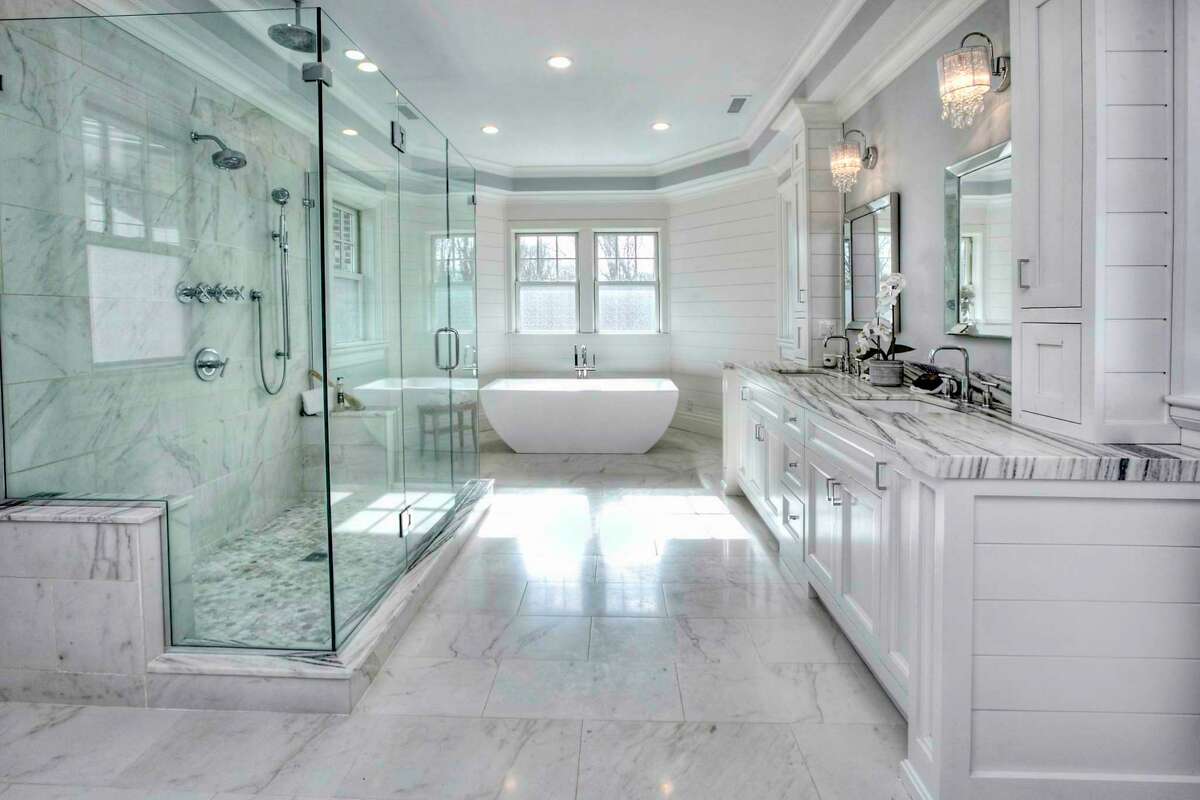 The luxurious marble master bath features a radiant heat marble, oversized glass shower, double vanity, and a soaking tub.